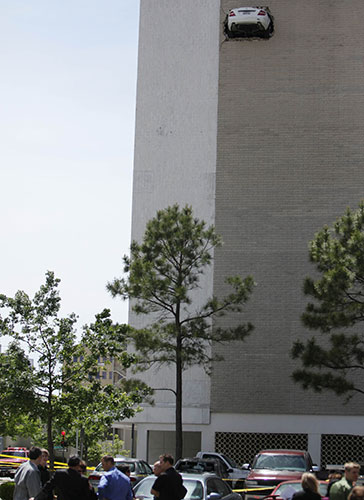 24 hours in pictures: Tulsa, USA: A car goes through the wall of 6th floor of a parking lot