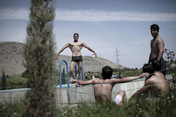 24 hours in pictures: Kabul, Afghanistan: Men enjoy a sunny day at a swimming pool