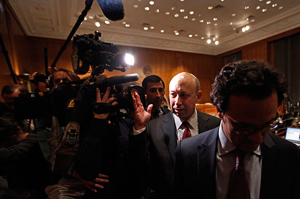Week in Business: Lloyd Blankfein of Goldman Sachs pushes away a tv camera after testifying