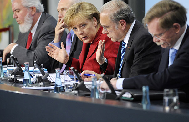 Week in Business: German Chancellor Angela Merkel gestures at a press conference