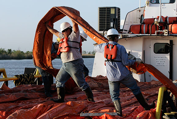 Deepwater oilrig: Workers load oil booms on boat in the Gulf of Mexico