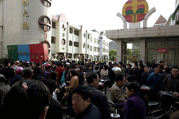 China school violence: People gather outside the gate of Zhongxin Kindergarten