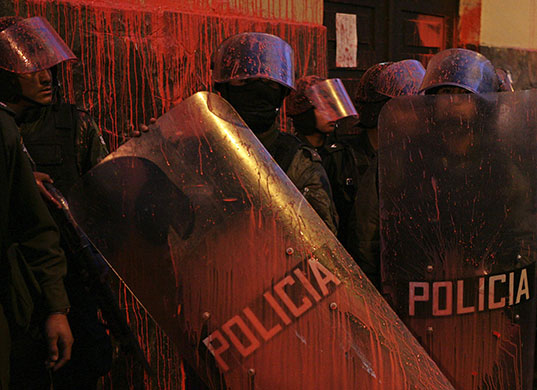 24 hours in pictures: Bolivian police stand guard during a protest in La Paz