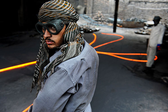 24 hours in pictures: Islamabad, Pakistan: Labourers work in a foundry