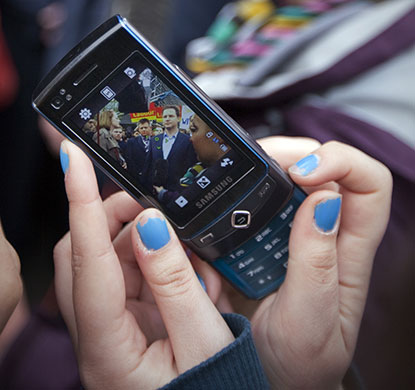 Campaigning with Clegg: A woman takes a photo on a mobile phone at De Montfort University