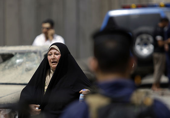 Baghdad explosions: A woman at the site of a car bomb attack near the Iranian Embassy
