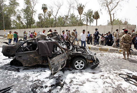 Baghdad explosions: Iraqis inspect the site of a car bomb attack near the Iranian Embassy