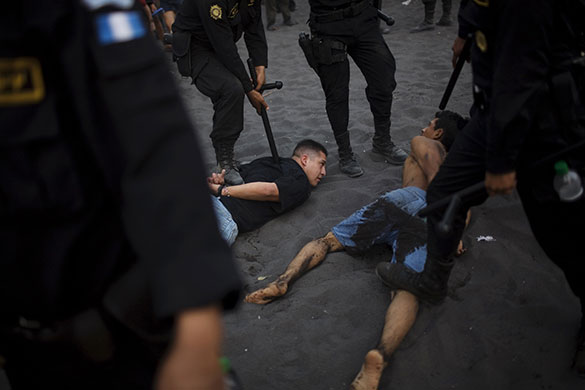 24 hours in pictures: Puerto San Jose, Guatemala: Police detain alleged thieves on a public beach