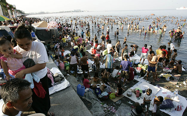 24 hours in pictures: Manila, Philippines: Families take a dip at the polluted waters of the bay
