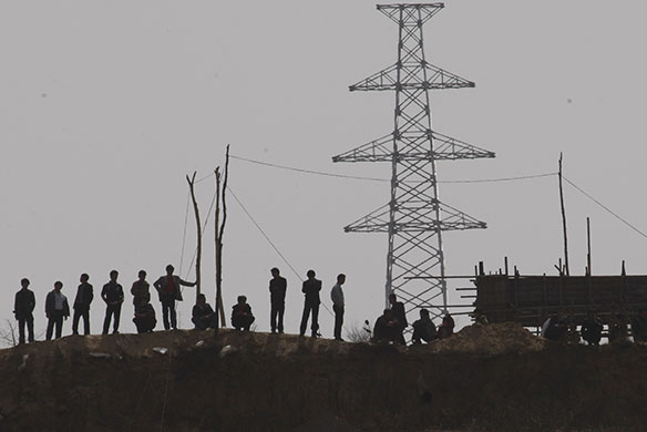 Miners rescued in China: Residents watch rescue work from the hillside near Wangjialing Coal Mine 