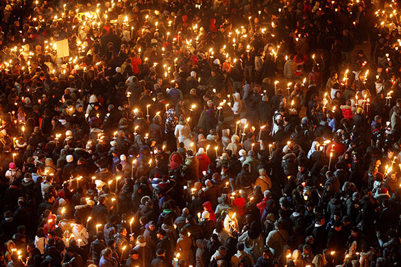 24 hours in pictures: L'Aquila, Italy: People take part in a torchlight procession