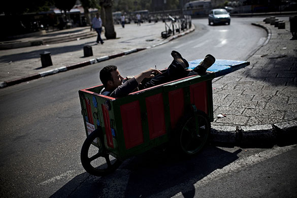 24 hours in pictures: Jeruslaem: A vendor rests in his cart
