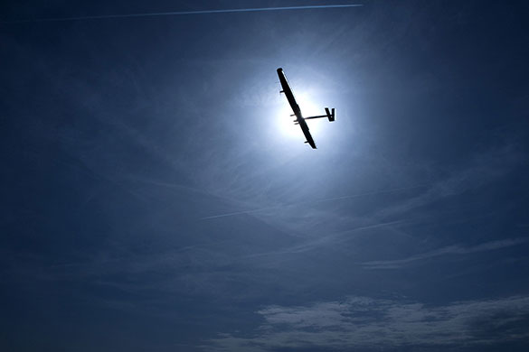Solar Impulse: Solar Impulse is silhouetted by the sun during its maiden flight