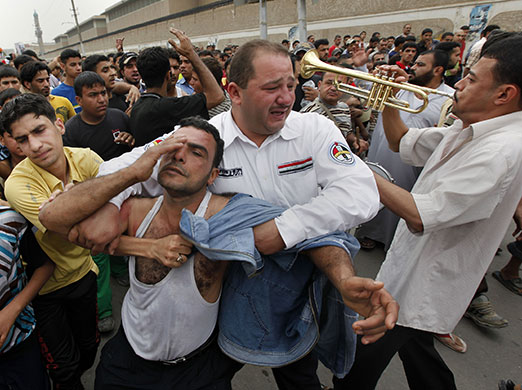 24 hours in pictures: funeral of victim of bomb attack in baghdad, iraq