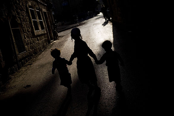 24 hours in pictures: Ultra-orthodox Jewish children walk in a street in Jerusalem