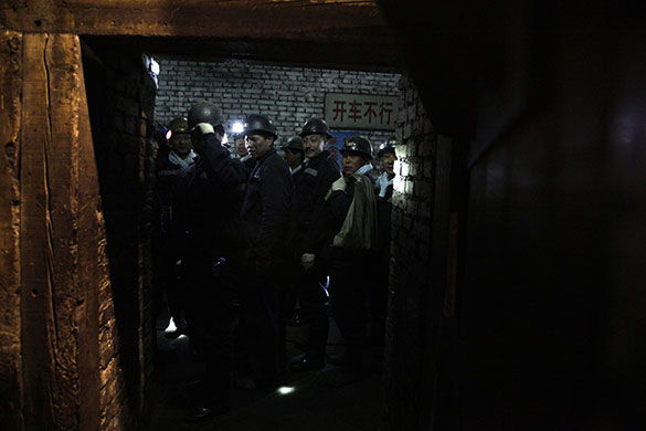 24 hours in pictures: Shanxi, China: Rescue workers at Wangjialing Coal Mine