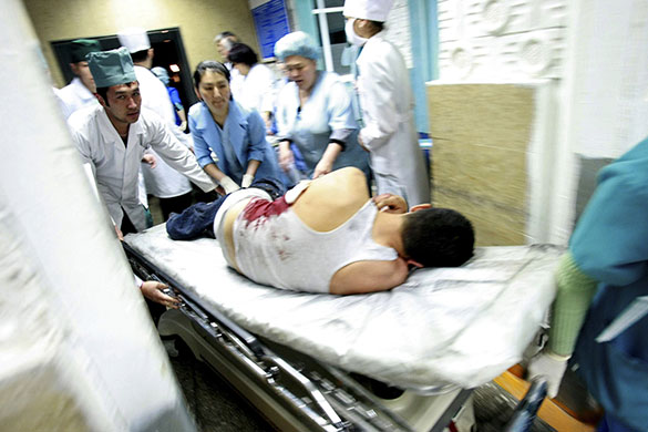 Kyrgyzstan: Medics attend to a man injured during clashes
