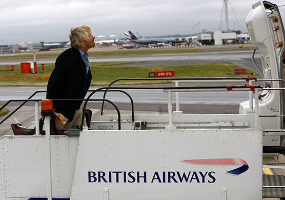 British Airways merger: 2008: British entrepreneur Richard Branson boards a British Airways plane