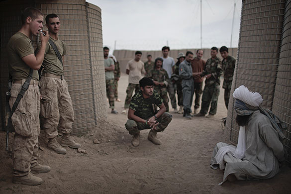 24hours: Two US Marines guard an Afghan detainee