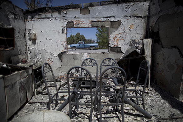 24hours: A truck passes by a burned house, Mexico
