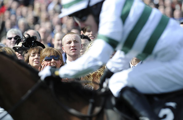 Grand National day one: A punter cheers on Tony McCoy on Barizan