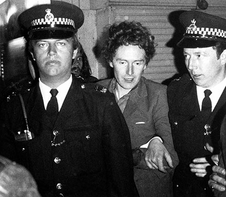 Malcolm McLaren: McLaren being led away by the police after his arrest, May 1977