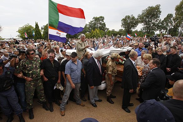Terreblanche update: Supporters of Eugene Terreblanche carry his coffin outside the church