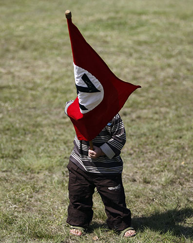 terreblanche update: A child waves a Afrikaner Resistance Movement (AWB) flag during the funeral