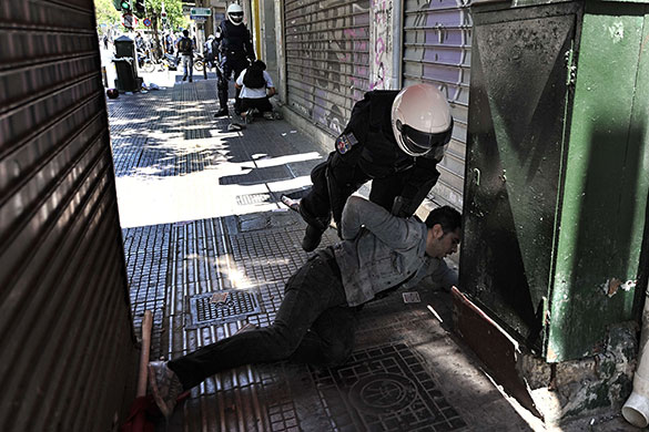 Athens Riot: A Greek police member detains a demonstrator during a May day protest