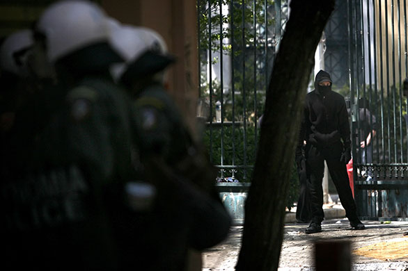 Athens Riot: A demonstrator outside the Polytechnic School during a protest in Athens 