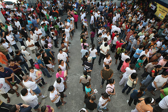 Philippine elections: Filipinos waiting to vote queue outside a voting precinct 