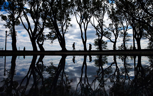24 hours in pictures: People walk along the waterfront trail along the lakeshore in Toronto