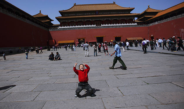 24 hours in pictures: A Chinese boy reacts as he visits the Forbidden City, Beijing, China