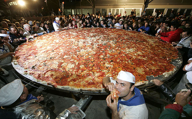 Big Food: Pizza makers surround a giant pizza