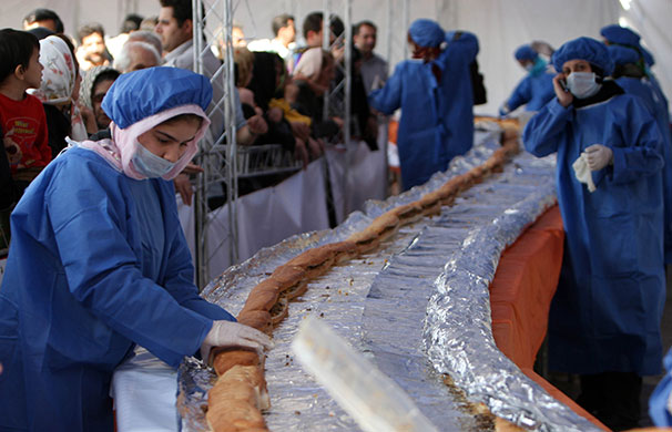 Big food: Workers prepare a giant ostrich meat sandwich in Iran