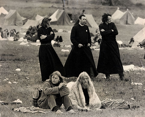 Glastonbury at 40: Three men dressed as priests walking in the Tent Field