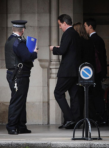 Cameron's big day: David Cameron makes his way to his office in the House of Commons