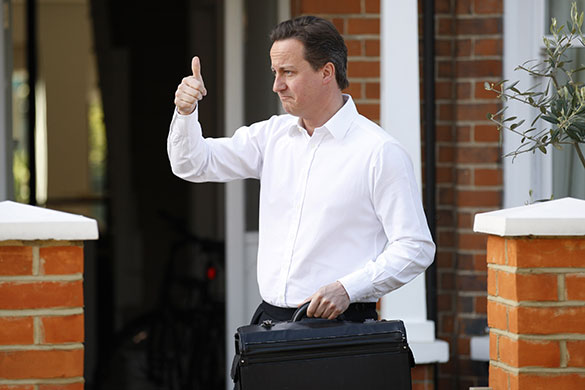 Cameron's big day: David Cameron gestures to his driver