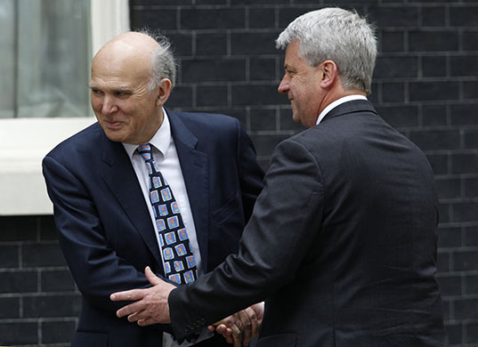 Conservatives arrive: Liberal Democrat MP, Vince Cable shakes hands with Andrew Lansley