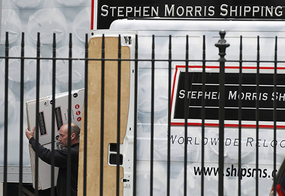 Conservatives arrive: A worker carries flat empty boxes from a removal van 