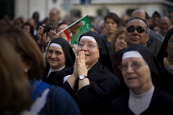 24 hours in pictures: Nuns watch Pope Benedict XVI on TV