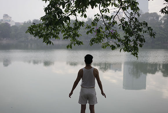 24 hours in pictures: Hanoi, Vietnam: A man exercises in front of a lake