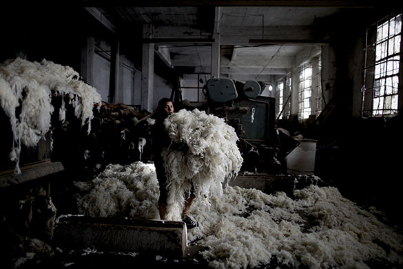 24 hours in pictures: Buenos Aires, Argentina: A worker carries wool in a cooperative factory