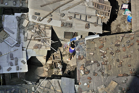 24 hours in pictures: Beijing, China: A woman hangs her laundry in an alley