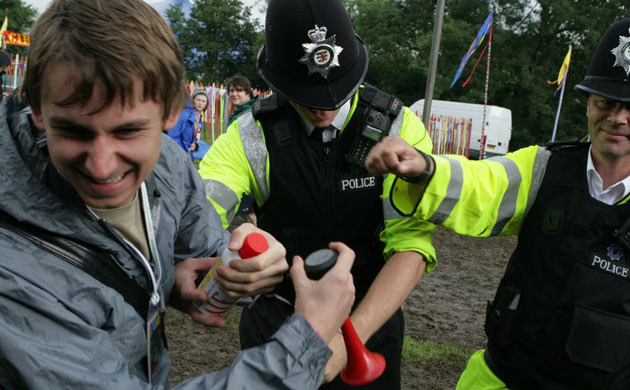 Glastonbury at 40: A festival goer is reprimanded by police at the Glastonbury festival