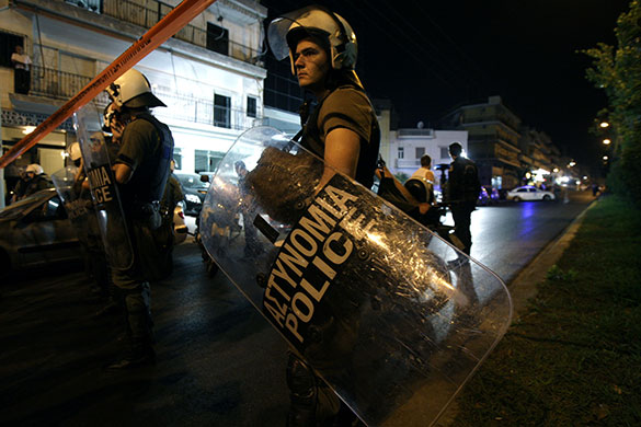 24 hours in pictures: Athens, Greece: Riot police officers secure an area near a prison