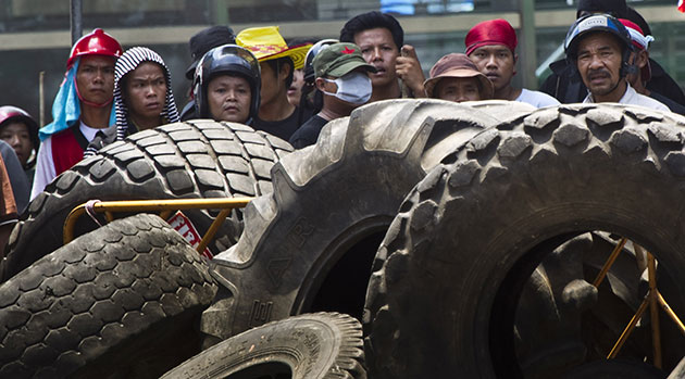 Thailand protests: Demonstrators watch soldiers from behind makeshift barricades