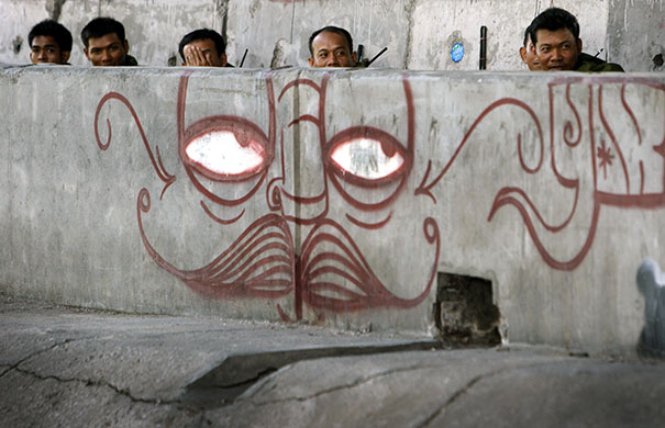Thailand protests: Soldiers rest under an overpass