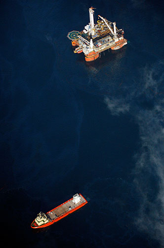 Deepwater Horizon: Gulf Oil Spill Begins To Reach Land: barge carries oil containment vessel