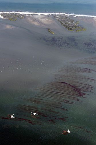 Deepwater Horizon: Oil Spill Begins To Reach Land:  Fishing boats drag booms through an oil